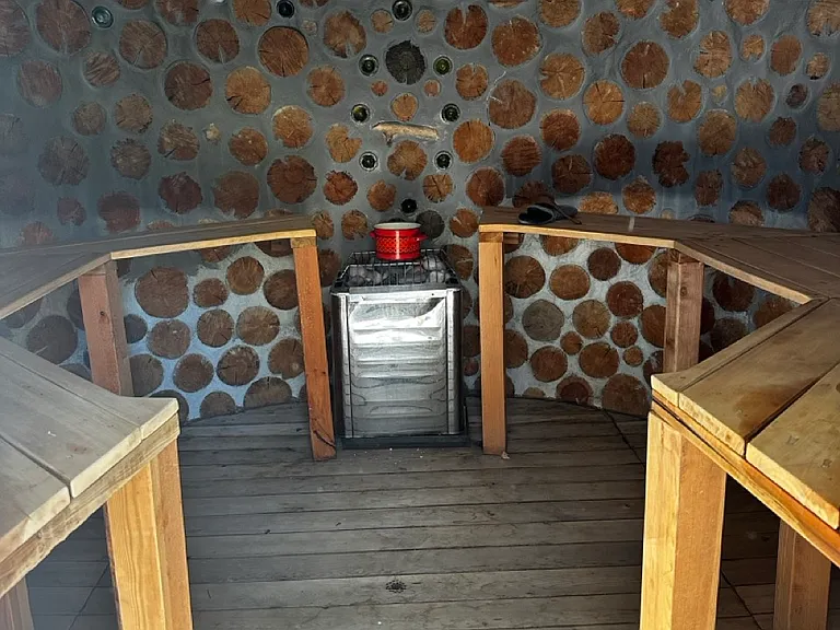 Relax in the 8-person cordwood sauna, designed for both wet and dry experiences.