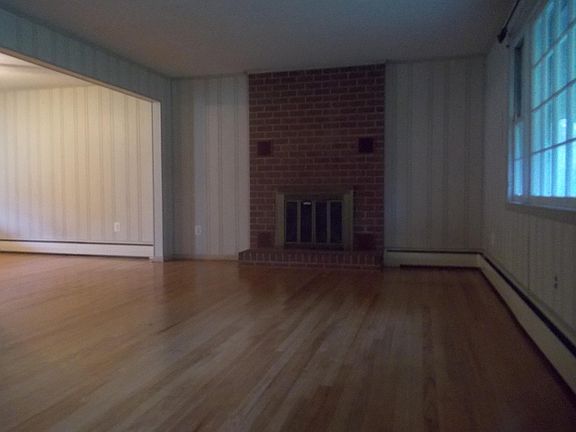 Living room with wood burning fireplace