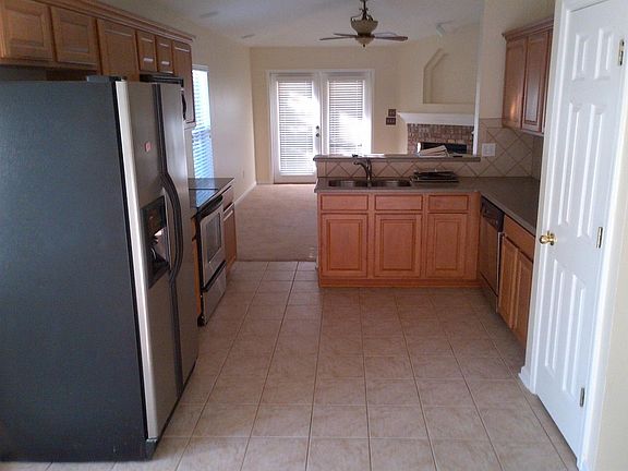 Kitchen with tile backsplash and tile floor