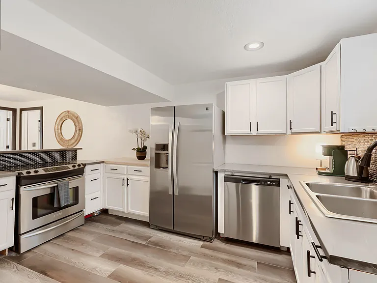 Full outfitted kitchen for Rooms 5-7 with assigned cabinet storage and fridge space.