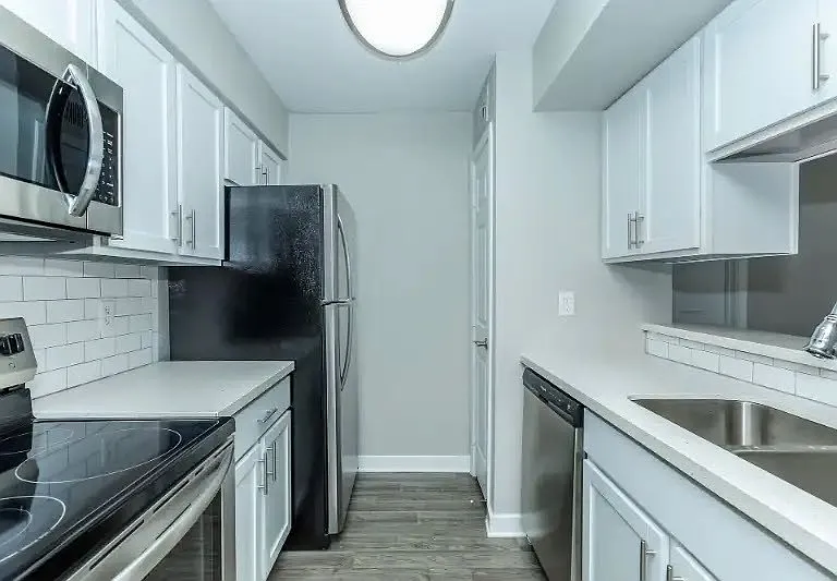 Experience a modern kitchen at Cali Crossing Apartments, featuring sleek stainless steel appliances, ample counter space, and elegant cabinetry. Elevate your living space today! Schedule a tour and see your new home.