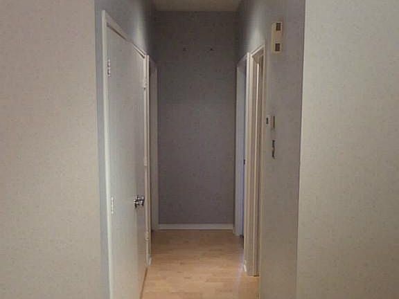 Hallway. Notice all hardware such as door knobs have been replaced.
