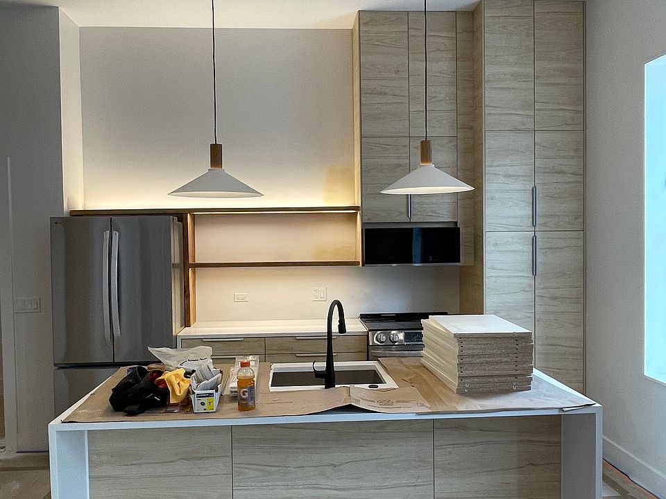 Kitchen with island. Has a dishwasher and garbage disposal.