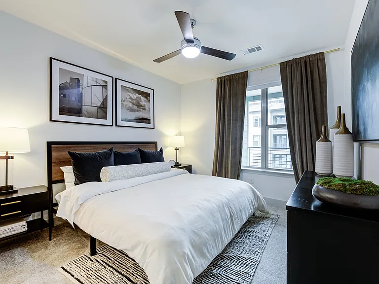 Bedroom With Cozy Carpet, King Bed, and Framed Photography