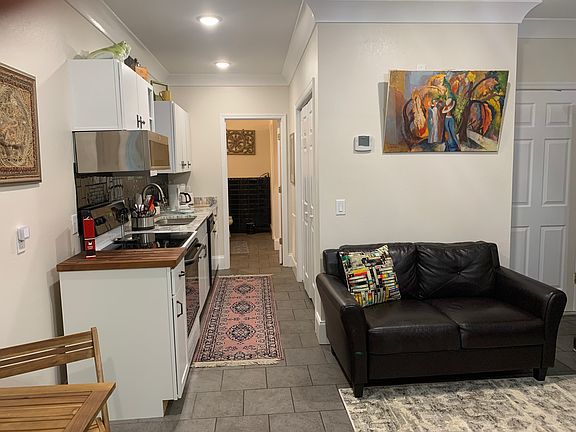 Looking down the kitchen Hallway. New granite countertop, cutting board, new microwave, oven/stove, dishwasher, fully furnished kitchen