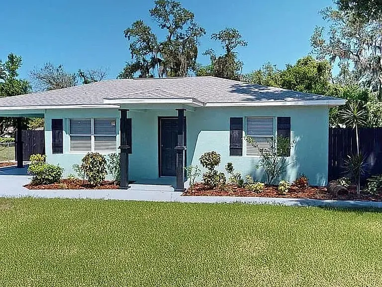 Freshly remodeled home with new landscaping, private driveway, and charming curb appeal in central Tampa