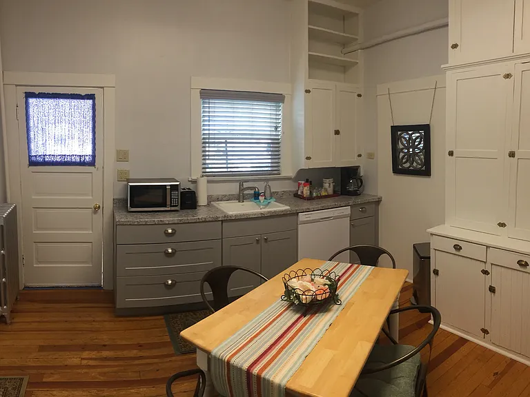 Eat in kitchen with dishwasher, refrigerator, microwave, table, chairs and lots of storage