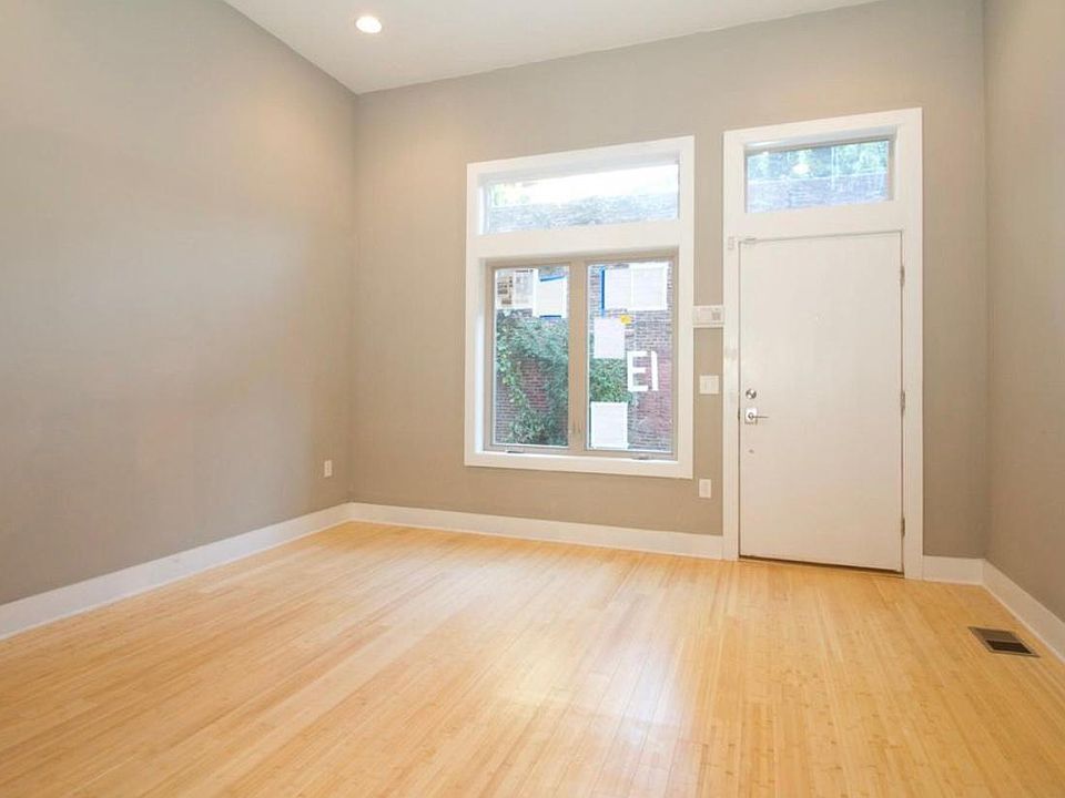 Entry into unit, transom windows allow plenty of sunlight and high ceilings elevate the space