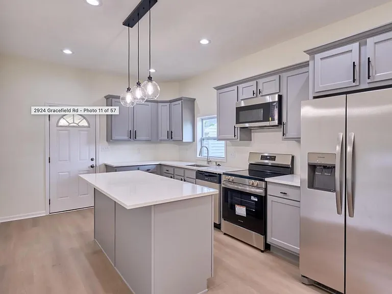 Updated kitchen with a center island, ample cabinet storage, and stainless-steel appliances for easy everyday cooking.