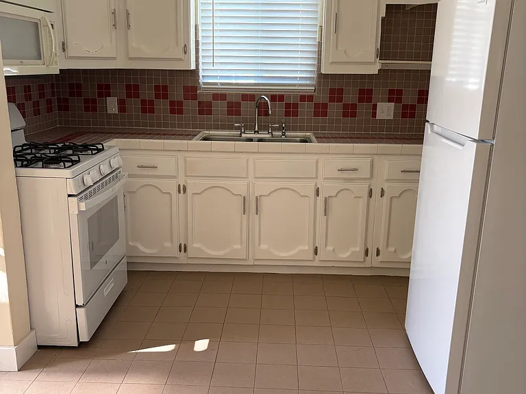 kitchen, gas stove and microwave, refrigerator and plenty of cabinets