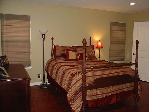 Large master bedroom with handscraped hardwood floors.
