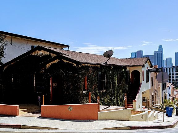 Front of property with downtown view