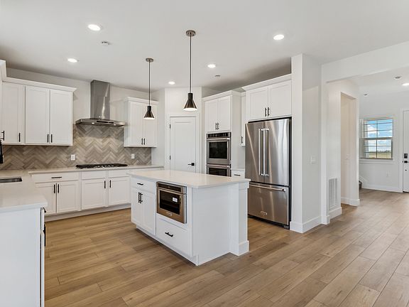 The beautiful kitchen has stainless steel, energy efficient appliances.
