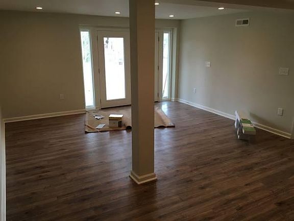 large living room with access to fenced in back yard and pri