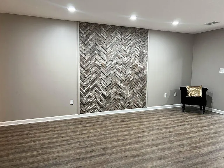 Living room with brick wall feature.