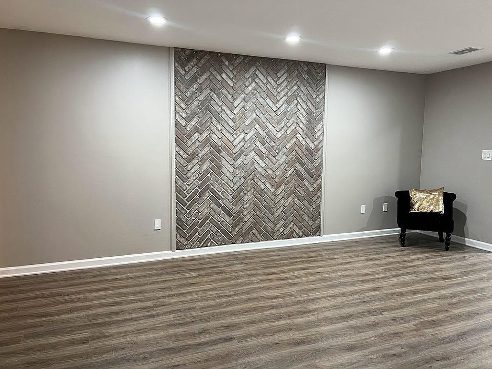 Living room with brick wall feature.