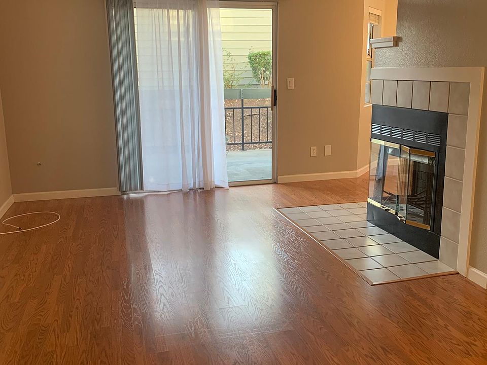 Living room with wood burning fireplace.