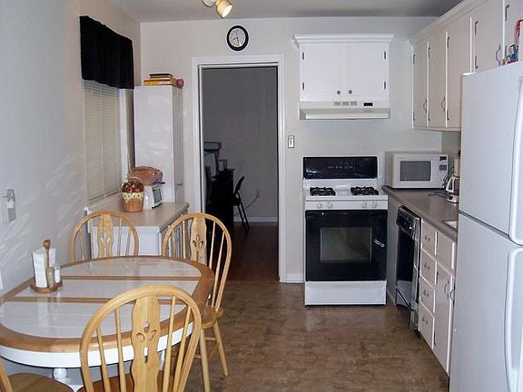 Kitchen w/freshly painted walls, cabinetry & new flooring.