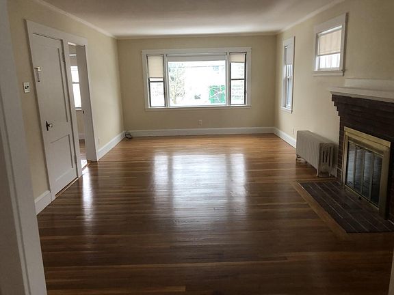This view shows the front room / living room. Shows front door and the front bedroom entrance.