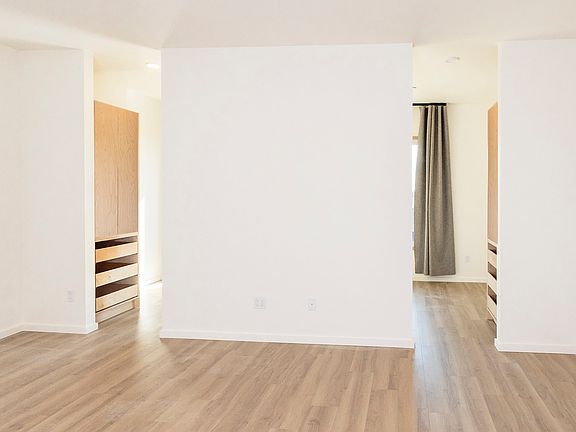 Full-height openings to bedroom let the natural light flow through the space