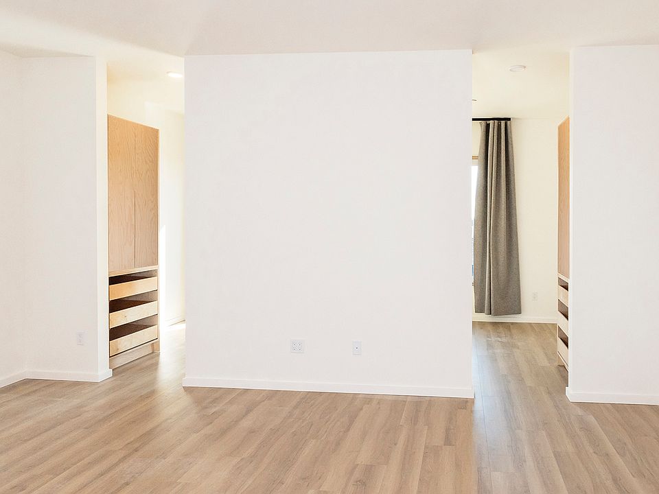 Full-height openings to bedroom let the natural light flow through the space