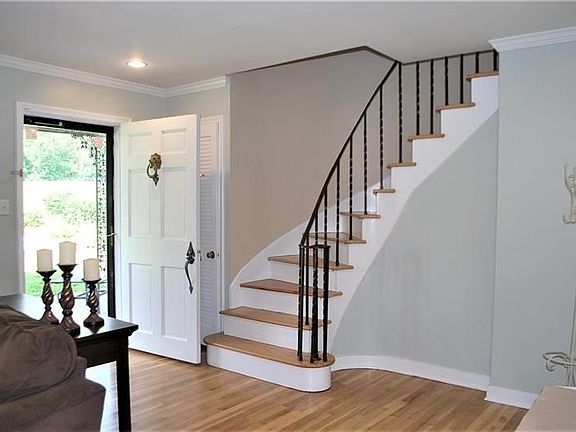 Beautiful entry has a curving stairway and convenient closet