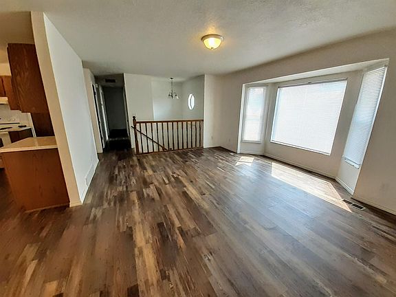 Front room w/ bay window. All new waterproof laminate