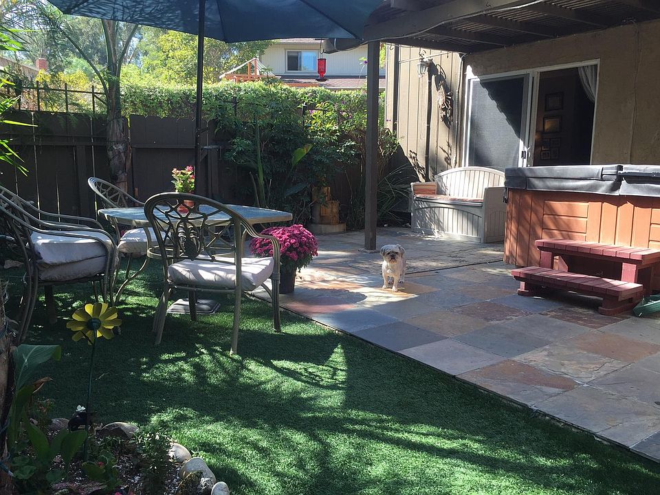 Spa no longer there. Neither is the dog! Fake grass in backyard for low maintenance. Perimeter is beautifully vegetated. Perfect for someone who likes to garden!