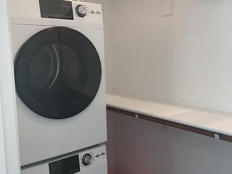 Stacked washer/dryer in bedroom closet