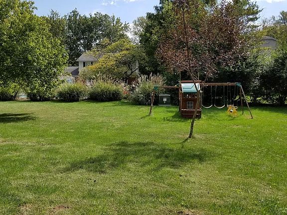 View of the back yard and play-set from the unit's patio