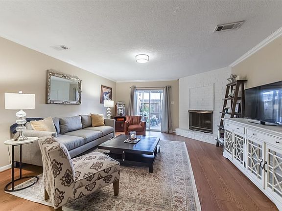Spacious Family room is light and bright featuring fireplace and new sliding doors leading to covered patio area perfect for entertaining outdoors!