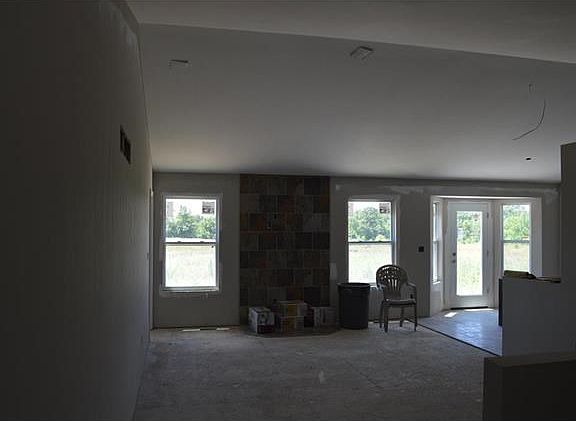 Vaulted great room - open to kitchen - tile to ceiling for fireplace