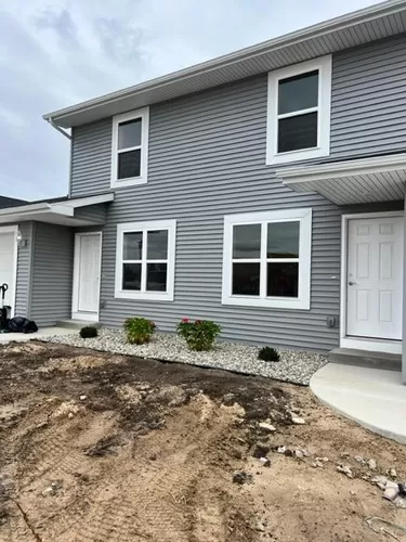The front of this townhome boasts beautiful landscaping and low maintence rock beds. - 8488 Rivers Bend Dr
