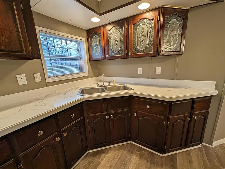 Window above sink with recessed lighting