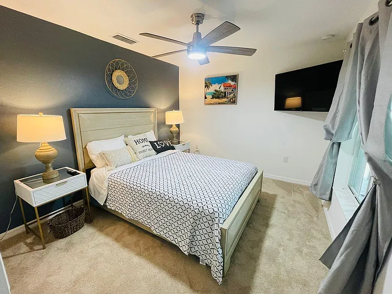 Guest bedroom with Queen bed and wall mount TV