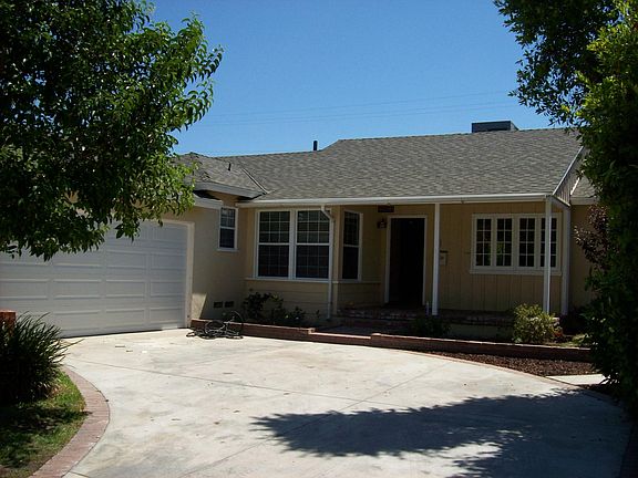 brick front porch; front door has stained glass design; kitc