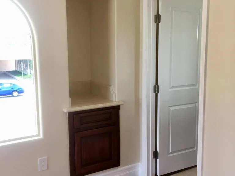 MASTER ENTRY TO MASTER BATH AND VIEW OF CUSTOM CABINET WORK