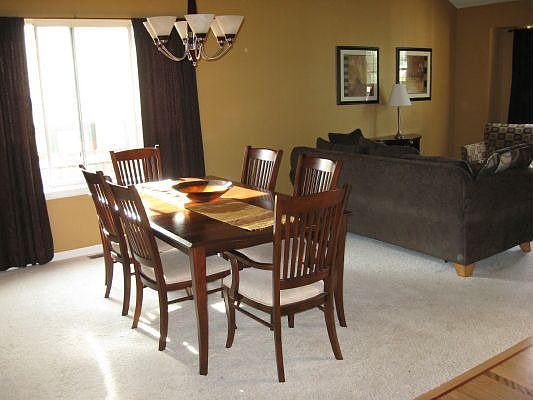 dining room/living room with vaulted ceilings