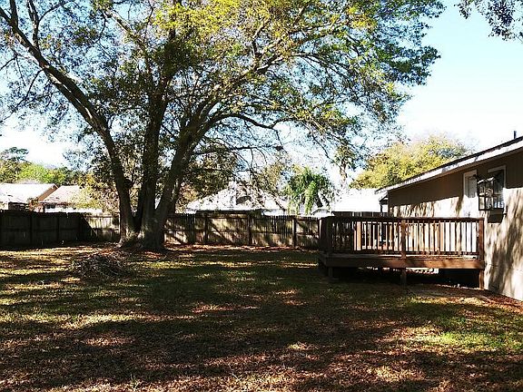 Large fenced back yard, and wood deck