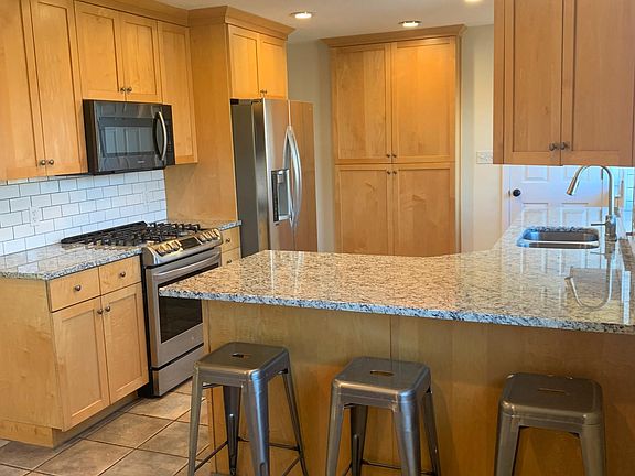 Kitchen with new granite and tile backsplash