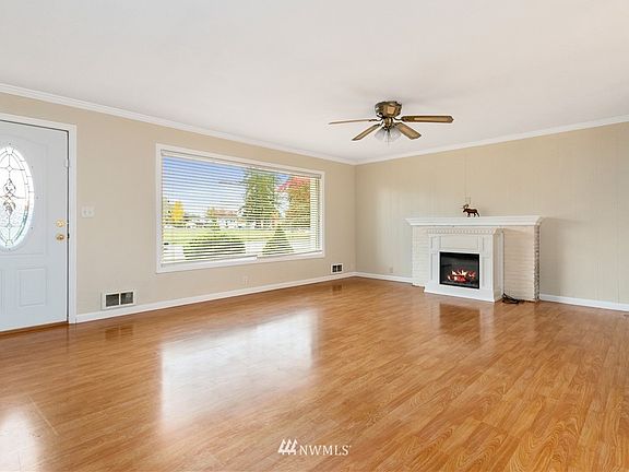Lovely light filled living room with cozy fireplace for year round enjoyment 