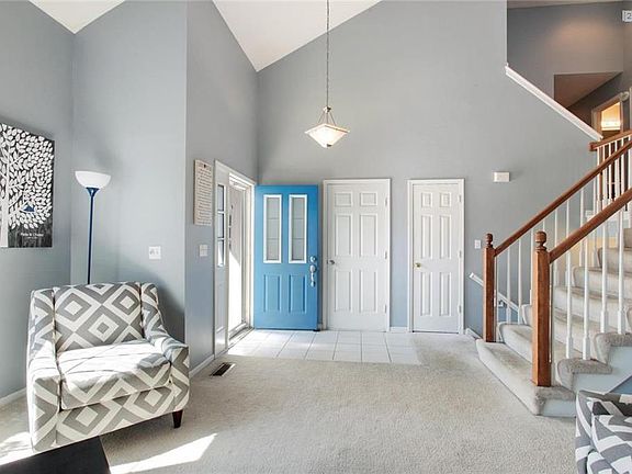 Great Room with a view of the tile Entry and door to the 3 car garage.