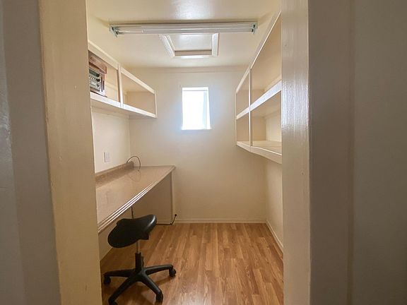 Separate office with lighting and plenty of shelf space.