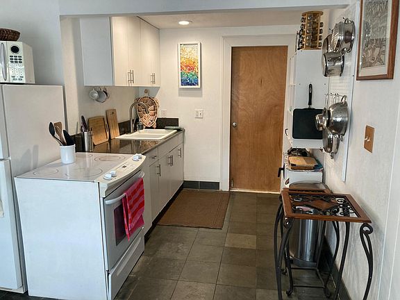 Full kitchen with everything you need to cook pans ,plates , cooking utensils full oven microwave ice box etc