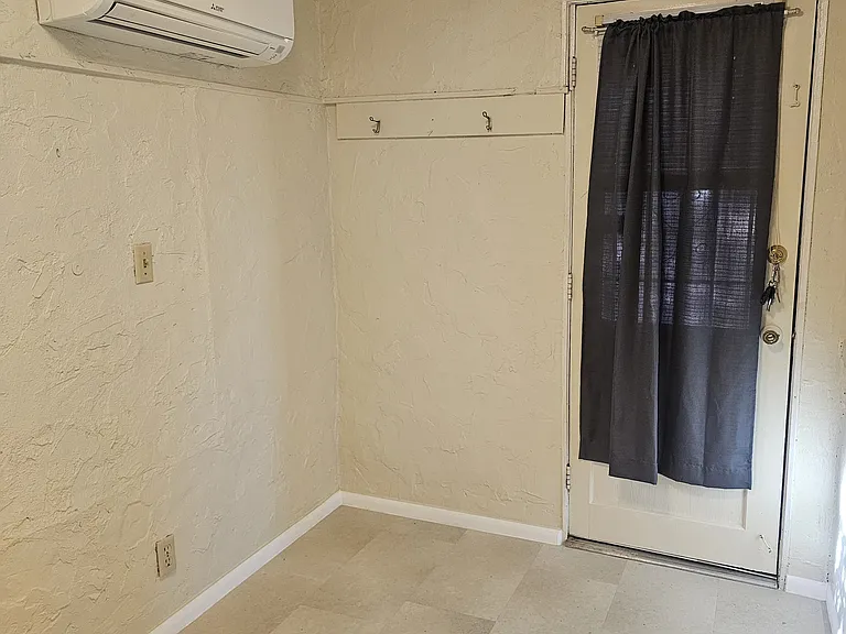 Bedroom with minisplit and security door, place for a tall dresser