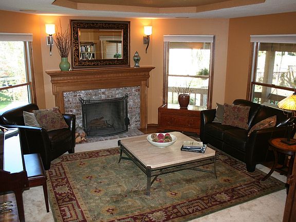 Living Room has 1 of the 3 fireplaces and beautiful windows and lighting