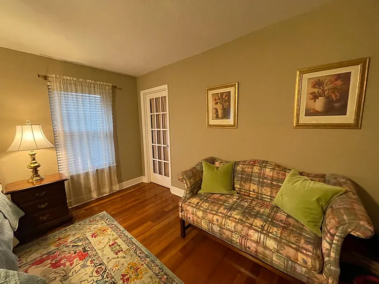 A comfortable couch in the large master bedroom.