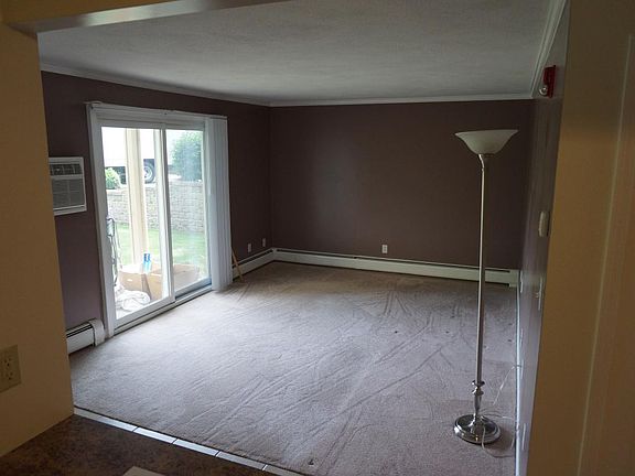 Living room with slider and yard/parking access