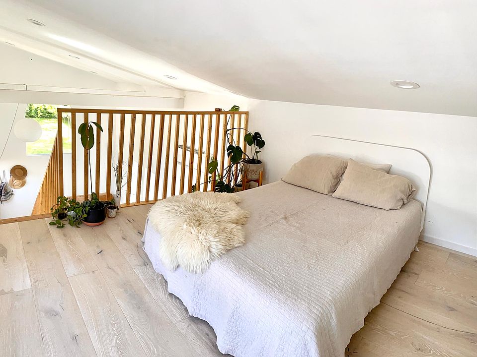 Sleeping loft with view of 80 year old pine, queen mattress, and build-in closets.