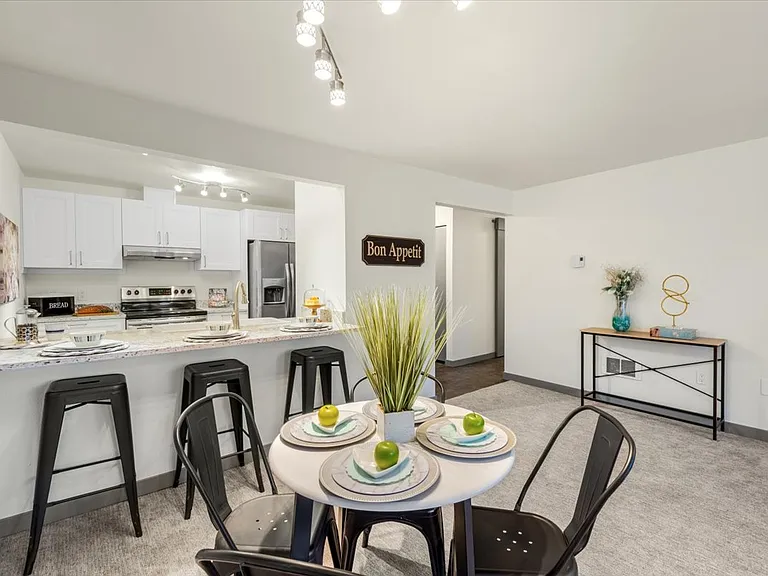 Eating nook to kitchen and hallway to bedrooms.